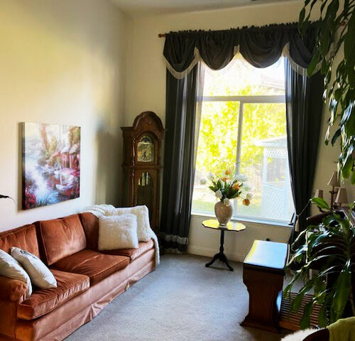 Cozy senior living space with hardwood floors and comfortable seating in Folsom, CA.