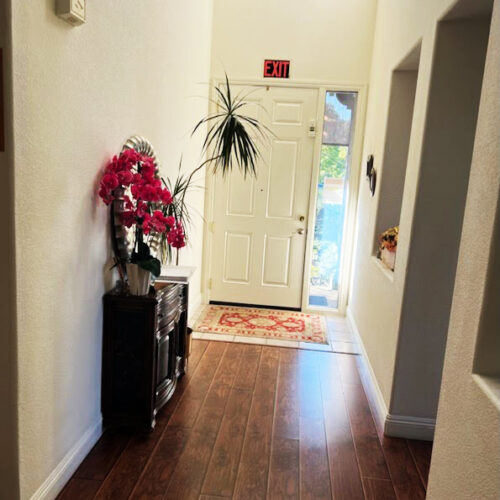 Elegant entryway with floral decor leading to a welcoming senior residence in Folsom.
